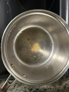 Cumin seeds sizzling in oil for jeera rice
