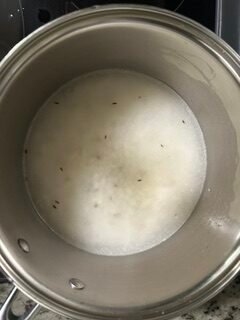Basmati rice with cumin seeds, water and salt cooking in a pan
