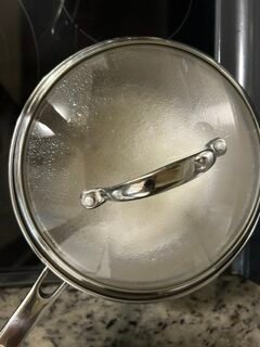 Basmati rice with cumin seeds, water and salt cooking in a pan