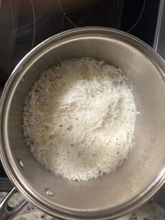 Cooked jeera rice in a pan with fluffy basmati rice and cumin seeds