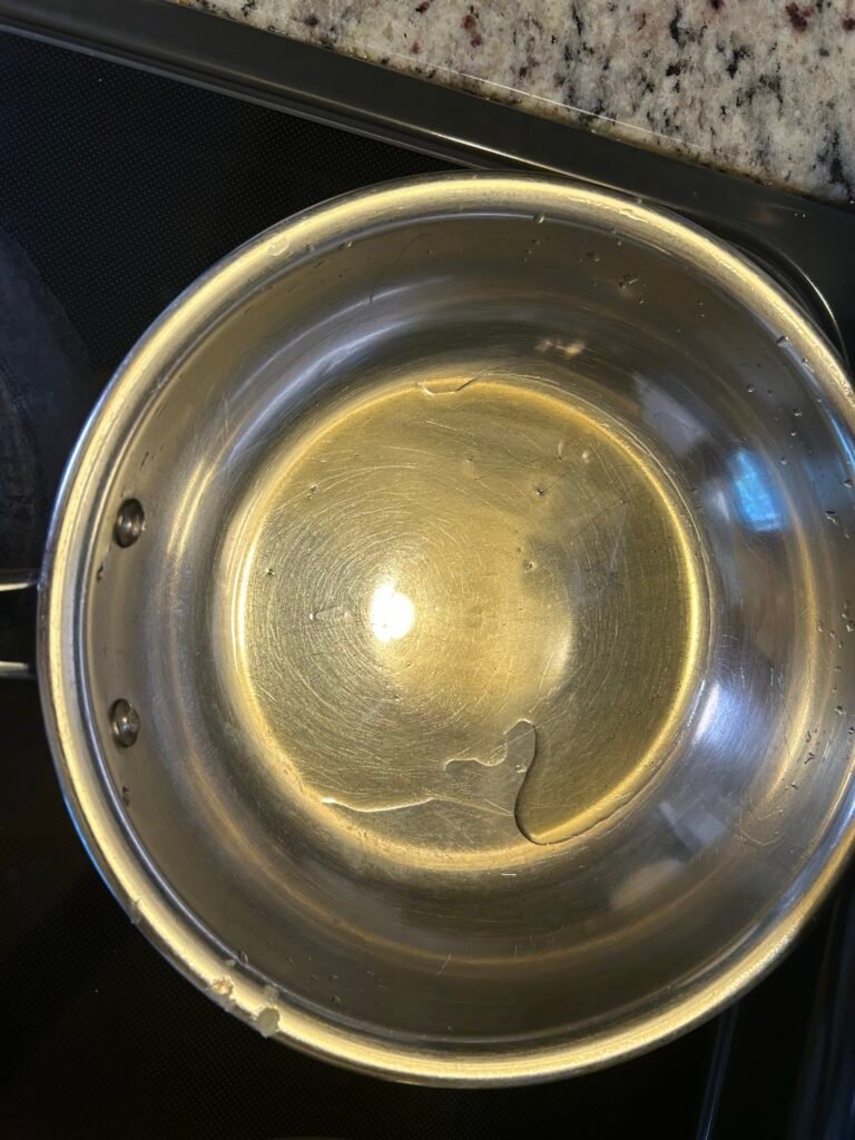 Ghee heating in a pan for homemade Kalakand