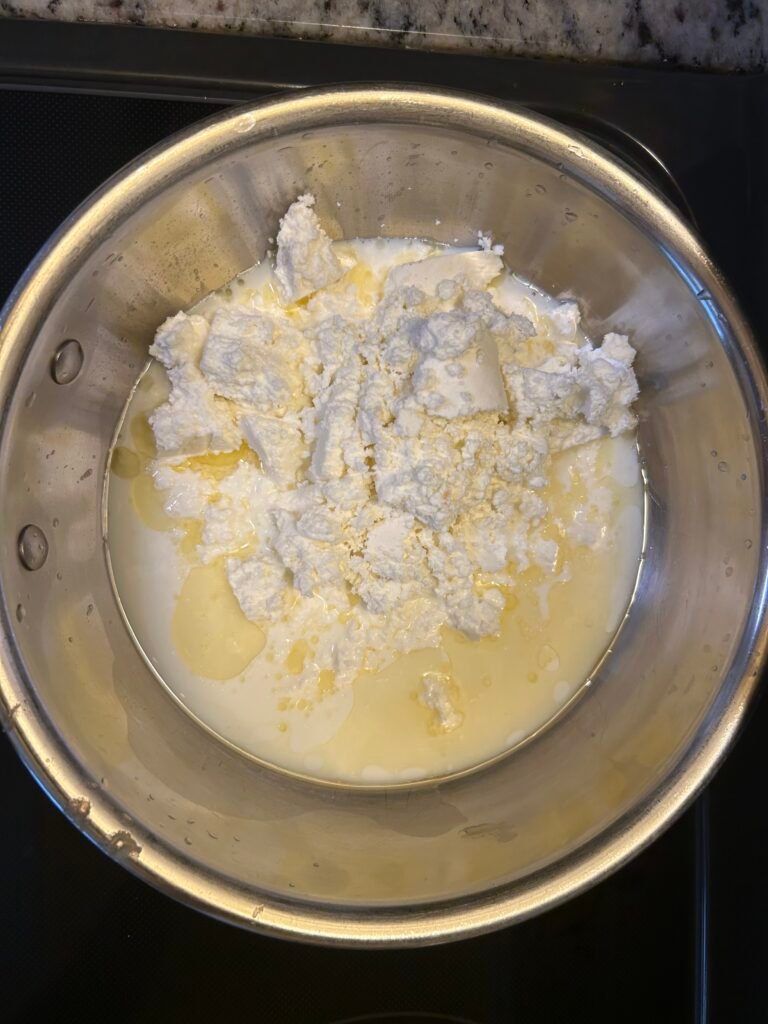Fresh paneer and milk added to a pan for Kalakand