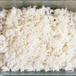 Leftover cooked white rice stored in a glass container