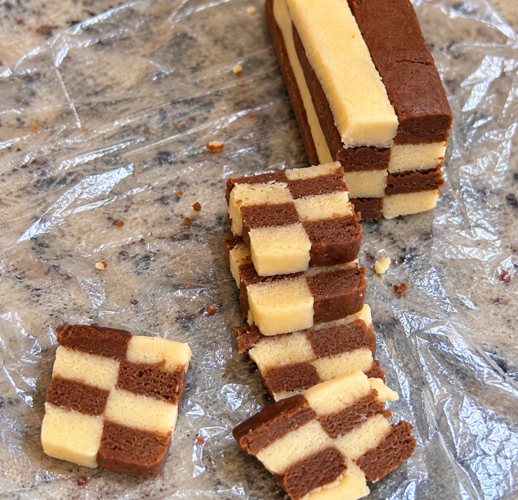 Sliced vanilla and chocolate cookie dough showing the checkerboard pattern