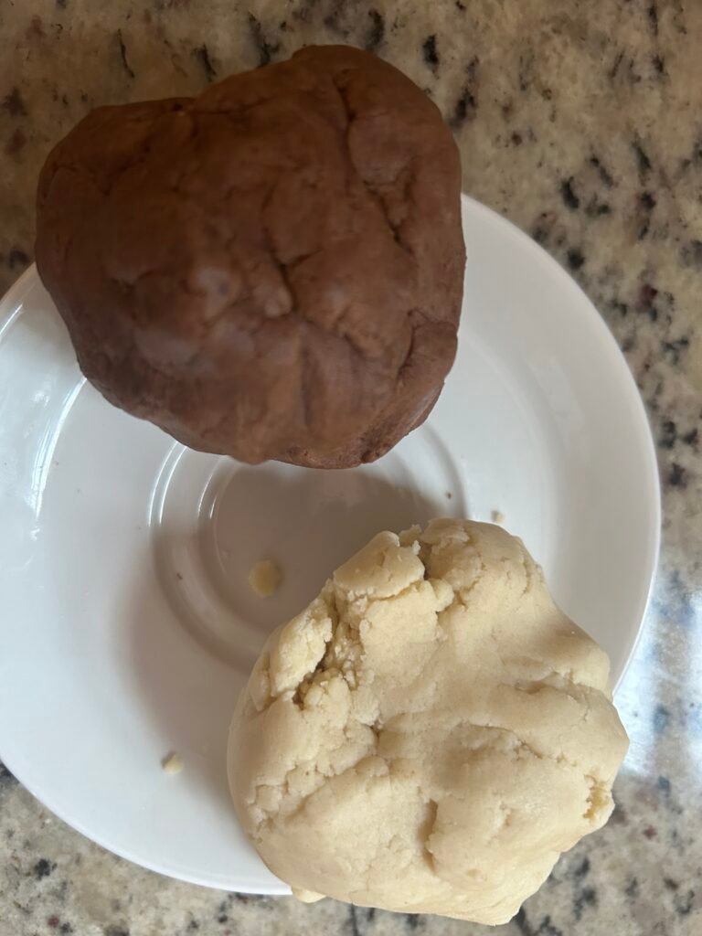 Vanilla and chocolate cookie dough prepared for shaping cookies