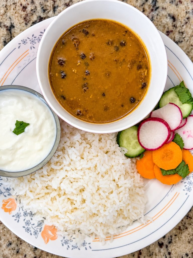 Homemade dal served with white rice, plain yogurt, cucumber, radish, and carrot salad.
Copy
