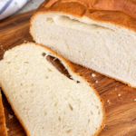 Freshly baked round homemade eggless bread with a golden-brown crust.